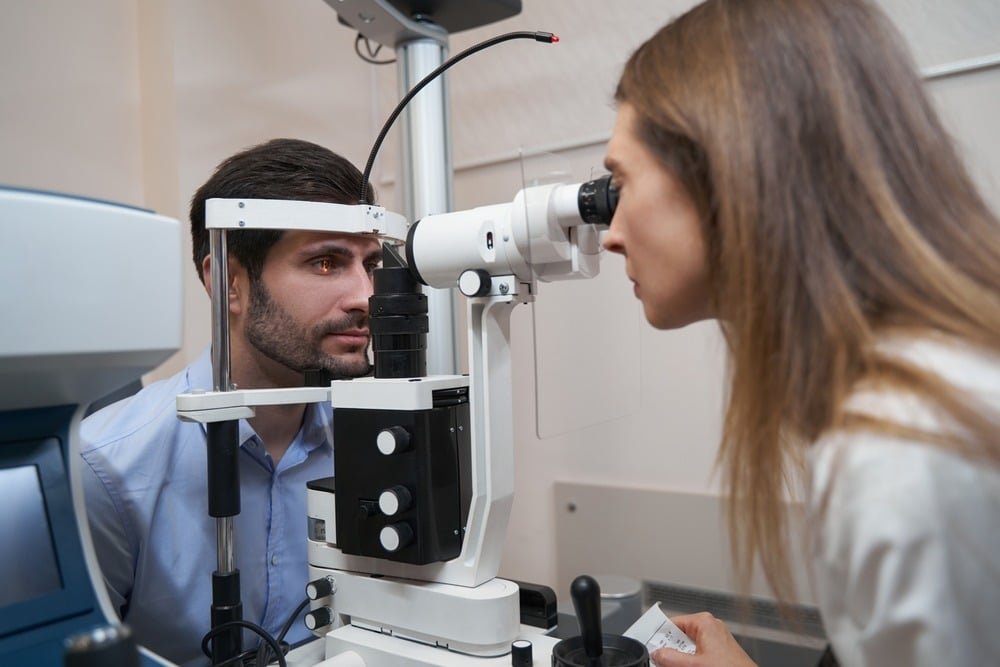 Ophthalmologist conducting a slit lamp examination on a patient,EVO300-SLIT-LAMP-5-STEP-LED,optinovate,optinovate-technologies,optical,optician,optometry,eyeclinic-equipment